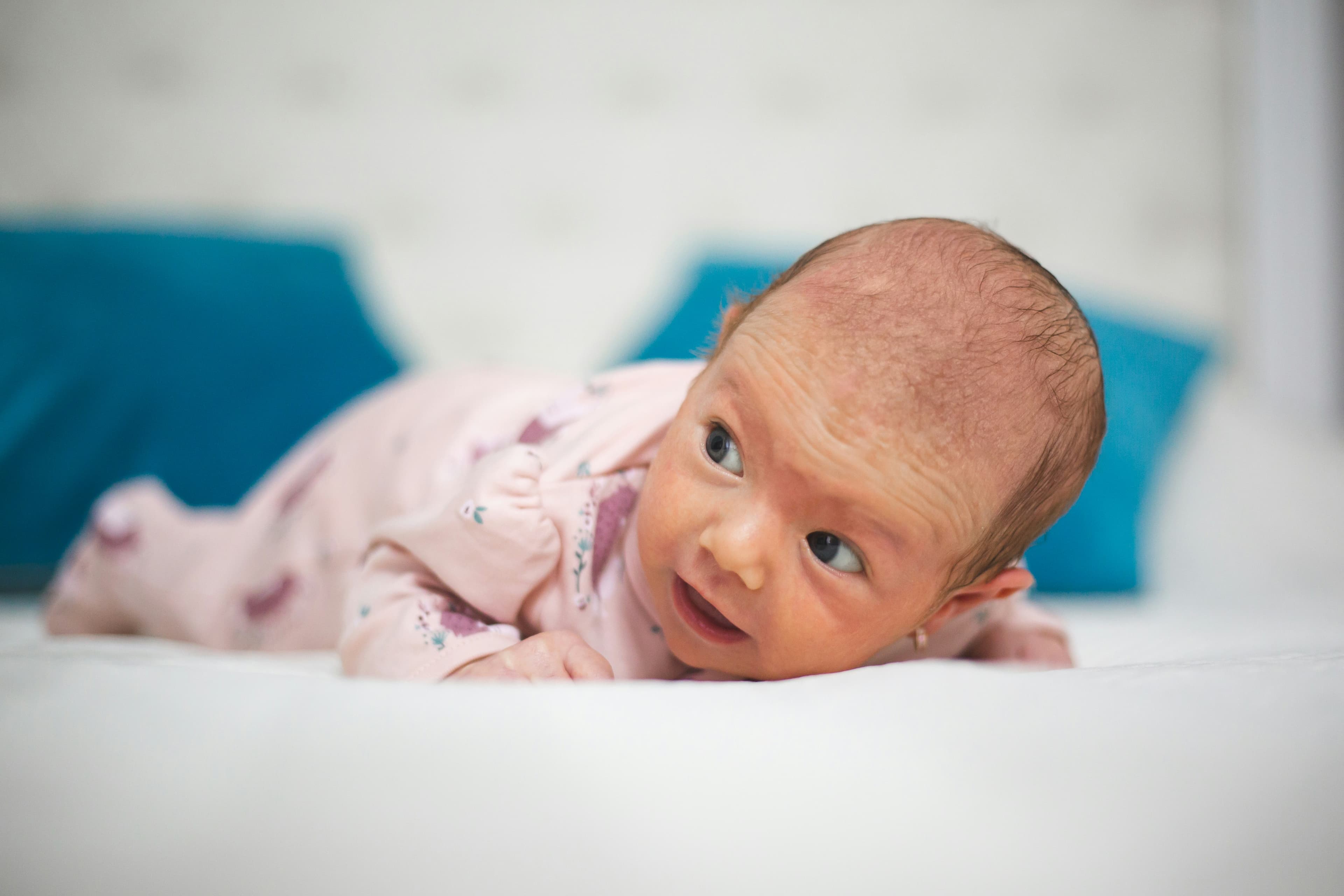 Infant lying on their back looking up
